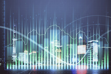 Financial graph on night city scape with tall buildings background double exposure. Analysis concept.