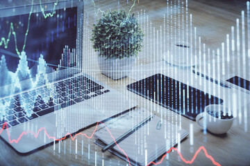 Forex market graph hologram and personal computer on background. Double exposure. Concept of investment.