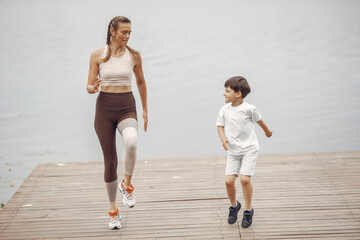 Mother with son doing workout by the river