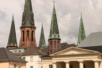 Fototapeta na wymiar Oldenburger Wahrzeichen im Fokus; Lambertikirche und Schlosswache vom Schlossplatz gesehen