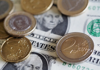 In this photoillustration Euro coins on the bacground of 2 dollar bills
