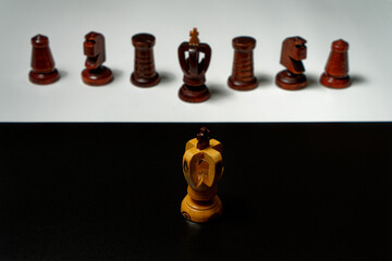 studio shot of black and white chess king on opositing background with boarder