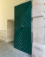 Green wooden door on street of Riga.