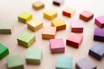 Roughly placed colorful wooden blocks with beautiful colors. All different colors.