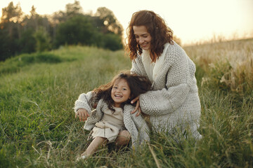 Fototapeta premium Mother with daughter playing in a summer field
