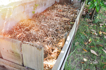 Composting of cut grass and fallen leaves to enrich soil. Leaf mulch. Organic fertilizer