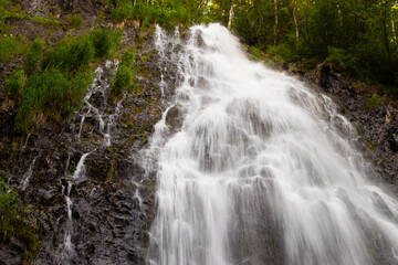 Waterfall flowing inside the rainforest area.