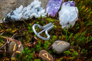 Rune stones on a moss. Different types of crystals on the forest floor. Future reading, life...