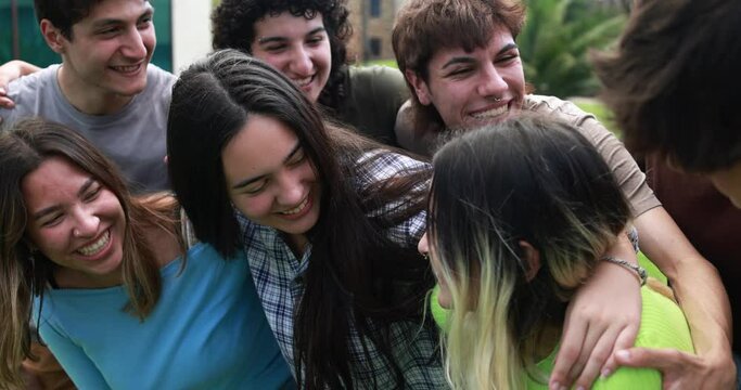 Young group of friends having fun outdoor with university on background 