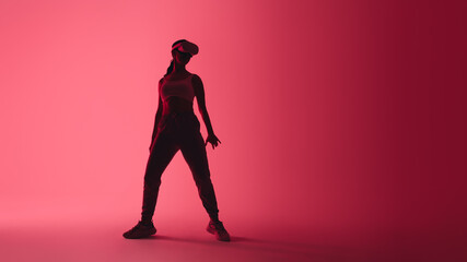 Fototapeta na wymiar Sporty young woman wearing virtual reality goggles in neon light