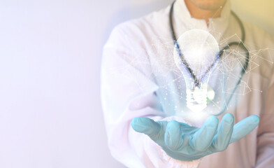 Naklejka premium Innovation. Concept new idea concept with innovation and inspiration, hands holding a light bulb Medical technology, digital healthcare, and network connection via hologram virtual interface.