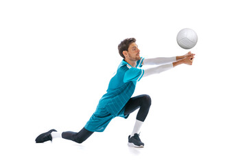 Portrait of young concentrated man, volleyball player in motion, training, playing isolated over...