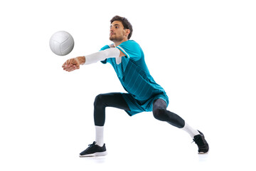 Portrait of young concentrated man, volleyball player in motion, training, playing isolated over...