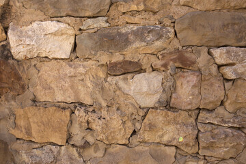 Masonry walls of natural sand color. Stone texture close-up, construction and mining background.