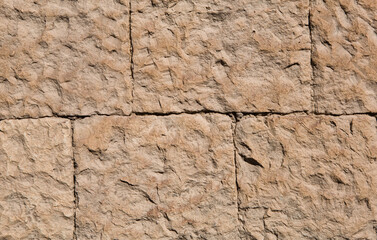 Masonry walls of natural sand color. Stone texture close-up, construction and mining background.