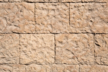 Masonry walls of natural sand color. Stone texture close-up, construction and mining background.