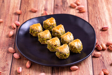 Pistachio baklava. Baklava filled with pistachio on a wooden floor. Turkish cuisine desserts. close up