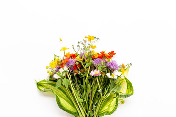 Fototapeta premium Bunch of wild meadow flowers and herbs chamomile, cornflower and ranunculus. Summer floral background