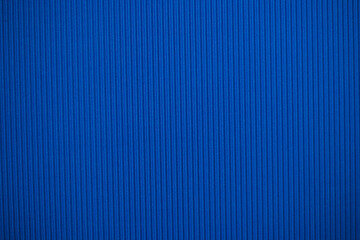 Abstract background made of corrugated paper for blue application. Space for text. Texture. Vertical stripes.