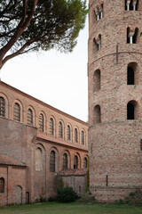 Fototapeta na wymiar Part of the facade and tower of a Romanesque basilica.