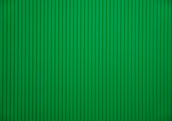 Abstract background made of corrugated paper for green application. Space for text. Texture. Vertical stripes. © Cherkasova Alie