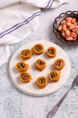 Bulbul Kadayif with Pistachio. Kadayif baklava with pistachio filling on a stone floor. Turkish cuisine desserts. Close-up. local name Antep Fıstıklı Bülbül Kadayıf