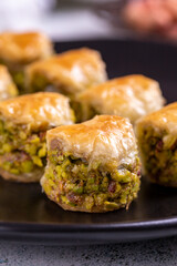 Pistachio baklava. Baklava filled with pistachio on a stone floor. Turkish cuisine desserts. close...