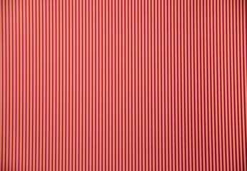 Obraz premium Abstract background made of corrugated paper for pink application. Space for text. Texture. Vertical stripes.