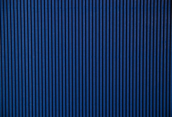 Abstract background made of corrugated paper for blue application. Space for text. Texture. Vertical stripes.