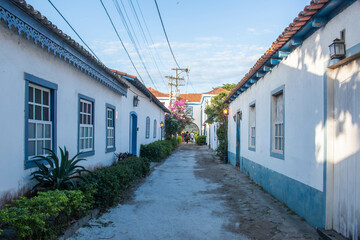 Fototapeta na wymiar Street with typical blue and white colonial houses, in the neighborhood of Passage, Cabo Frio, Brazil.