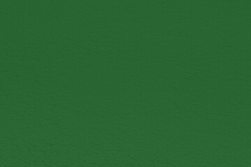 Saturated pastel dark green colored low contrast Concrete textured background. Empty colourful wall texture with copy space for text overlay and mockups. 2023, 2024 color trend