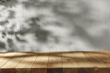 Wooden desk and wall with shadows. 