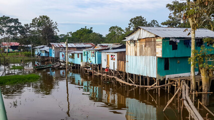 Puerto Narino, Colombia - Feb. 13, 2017: Beautiful stilt houses built on piles over the brown water...