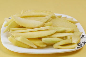  yellow ripe cut mango in a bowl top down 