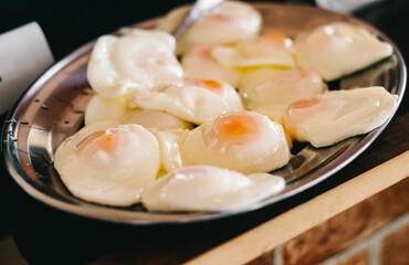 Tray with fried eggs who are part of a steak served in a restaurant