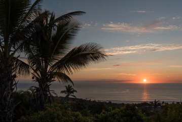 Fototapeta na wymiar Beautiful, tropical sunset at La Reunion, sun over the sea with orange sky