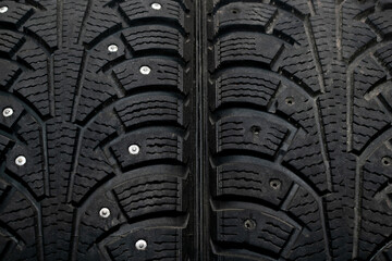 Car tires with traces of use. There are no spikes on one tire. The concept of proper driving by car