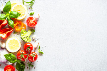 Fresh vegetables, herbs and spices on white background. Ingredients for cooking. Top view with copy space. © nadianb