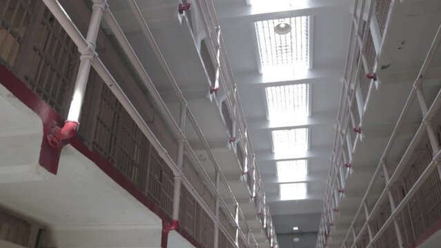 inside Alcatraz prison block corridor in San Francisco, California. low angle view of Bars, Cells and ceiling