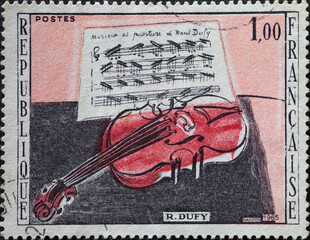 FRANCE - circa 1965: a postage stamp from FRANCE, showing a red violin in front of a sheet of...