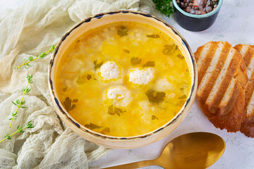 Creamy soup with chicken meatballs. Meatball soup in bowl