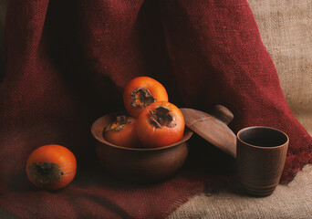still life with persimmons and earthenware