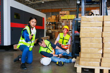 First Aid and safety first. Engineering talking on walki talki radio to employee while his...