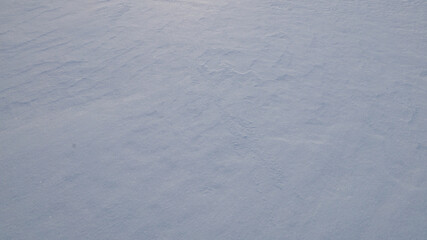 Texture of white snow with natural roughness.