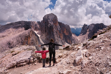 two people observing the altarpieces of san martino dolomites of trentino alto adige - obrazy, fototapety, plakaty