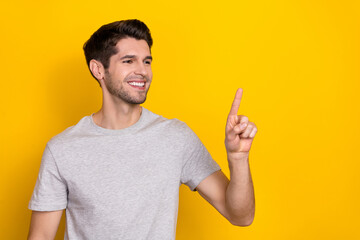 Photo of boss brunet millennial guy index promo wear grey t-shirt isolated on yellow color background