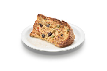 Slice of dried fruits panettone, on a white plate, isolated on white background