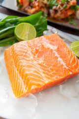Salmon fillet. Fresh raw salmon is placed on ice with a slice of lemon next to it.
