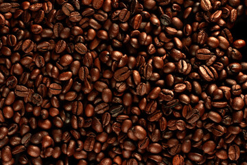 Top view of roasted coffee beans for background and texture. Piled of roasted coffee beans can be used as a background and texture.
