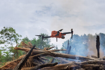 Fire services follow the fire in the forest trees with a drone with natural disaster